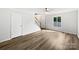 Bright living room with natural light, hardwood floors, ceiling fan, and staircase at 1908 Harvest Ln # 5, Charlotte, NC 28210