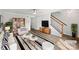 Bright living room with modern furnishings, stylish rug, ceiling fan, and staircase at 1908 Harvest Ln # 5, Charlotte, NC 28210