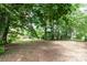 Expansive backyard with mature trees provides a serene and private outdoor space at 1936 Russell Ave, Charlotte, NC 28216
