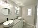 Bright bathroom with dual vessel sinks, granite countertop, modern lighting, and stylish tile flooring at 1936 Russell Ave, Charlotte, NC 28216