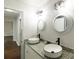 Bathroom with dual vessel sinks, granite countertop, modern lighting fixtures, and attractive white vanity at 1936 Russell Ave, Charlotte, NC 28216