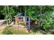 Charming brick home featuring a cheerful blue door framed by mature trees and a well-manicured lawn at 1936 Russell Ave, Charlotte, NC 28216