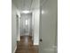Bright hallway featuring hardwood floors and a view to a bathroom with tiled floor at 1936 Russell Ave, Charlotte, NC 28216