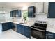 This renovated kitchen showcases blue cabinets, quartz countertops, stainless appliances, and herringbone backsplash at 1936 Russell Ave, Charlotte, NC 28216