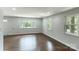 Bright living room with refinished hardwood floors and an abundance of natural light shining through multiple windows at 1936 Russell Ave, Charlotte, NC 28216