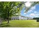 Expansive backyard view showcasing green lawn and back of home with many windows at 2013 Arbor Crest Ct, Charlotte, NC 28262