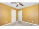 A simple bedroom featuring two doors and a ceiling fan at 2013 Arbor Crest Ct, Charlotte, NC 28262