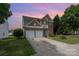 Charming brick two-story home featuring a two-car garage and a small balcony overlooking the front yard at 2013 Arbor Crest Ct, Charlotte, NC 28262