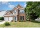 Charming brick two-story home featuring a two-car garage and a small balcony overlooking the front yard at 2013 Arbor Crest Ct, Charlotte, NC 28262