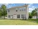 Two story home with vinyl siding, ample windows, sliding doors and a green lawn at 2013 Arbor Crest Ct, Charlotte, NC 28262
