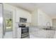 Kitchen with stainless steel appliances, white cabinets, marble countertops, and tile floors at 2013 Arbor Crest Ct, Charlotte, NC 28262