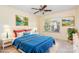 Bedroom is virtually staged with ceiling fan, large window and two decorative pictures at 2013 Arbor Crest Ct, Charlotte, NC 28262