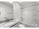 Bright bathroom featuring a granite countertop, modern fixtures, and a shower and tub combo at 208 N Correll St, Landis, NC 28025