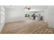 Open-concept living space combining the living room and kitchen with modern appliances and wood grain flooring at 208 N Correll St, Landis, NC 28025