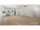 Open living space with wood grain floors, a kitchen with white cabinets and stainless steel appliances at 208 N Correll St, Landis, NC 28025