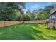 Large backyard enclosed with a wood privacy fence and featuring lush green grass at 2414 E 7Th St, Charlotte, NC 28204