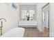Modern bathroom featuring a floating double sink vanity and a soaking tub at 2414 E 7Th St, Charlotte, NC 28204