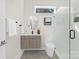 Modern bathroom features a floating vanity, toilet, and glass enclosed walk-in shower at 2414 E 7Th St, Charlotte, NC 28204