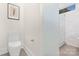 Powder room featuring a toilet, a frosted glass shower, and modern artwork at 2414 E 7Th St, Charlotte, NC 28204