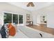 Bright bedroom featuring a private balcony, hardwood floors, and a modern ceiling fan at 2414 E 7Th St, Charlotte, NC 28204