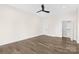 Bedroom featuring hardwood floors, a ceiling fan, and a spacious closet at 2414 E 7Th St, Charlotte, NC 28204