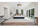 Bright bedroom with white walls, hardwood floors, and a large window, with a cozy rug at 2414 E 7Th St, Charlotte, NC 28204