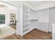 Large walk-in closet featuring custom shelving and drawers, leading into the primary bedroom at 2414 E 7Th St, Charlotte, NC 28204
