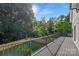 Spacious deck overlooking a fenced backyard surrounded by mature trees at 2414 E 7Th St, Charlotte, NC 28204