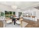 Bright dining area featuring a modern chandelier, table for six, and a view of the open kitchen at 2414 E 7Th St, Charlotte, NC 28204