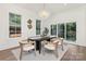 Elegant dining room featuring a modern light fixture, large windows, neutral decor, and hardwood flooring at 2414 E 7Th St, Charlotte, NC 28204