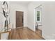 Inviting foyer with hardwood floors, modern decor, and a view into another bright room at 2414 E 7Th St, Charlotte, NC 28204