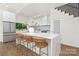 Modern kitchen with marble island, sleek white cabinetry, and stainless steel appliances at 2414 E 7Th St, Charlotte, NC 28204