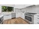 Bright kitchen featuring stainless steel appliances, white cabinets, quartz countertops, and a farmhouse sink at 2414 E 7Th St, Charlotte, NC 28204