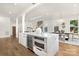 Open kitchen with marble island with wine fridge and stainless steel appliances at 2414 E 7Th St, Charlotte, NC 28204
