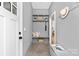 Well-organized mudroom with built-in storage shelves, hooks, bench, and neutral color scheme at 2414 E 7Th St, Charlotte, NC 28204