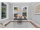 Cozy office space with two windows, a modern desk, neutral color palette, and hardwood floors at 2414 E 7Th St, Charlotte, NC 28204