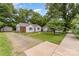 Charming single-story home featuring mature trees and a well-maintained lawn at 2601 Ashley Rd, Charlotte, NC 28208