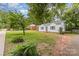 Charming home with a well-maintained front yard, complemented by mature trees, lush greenery and inviting curb appeal at 2601 Ashley Rd, Charlotte, NC 28208