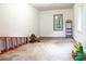 Spacious garage interior featuring a clean, concrete floor, bright windows, and potential for a workshop or storage area at 2601 Ashley Rd, Charlotte, NC 28208