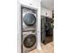 Laundry closet with stacked washer and dryer next to a stainless steel refrigerator at 2601 Ashley Rd, Charlotte, NC 28208