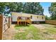 An overview of the backyard, featuring a wooden deck and full fencing at 2903 Price Rushing Rd, Monroe, NC 28110