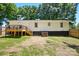 View of the backyard, featuring a wooden deck, partial grass, and full fencing at 2903 Price Rushing Rd, Monroe, NC 28110