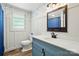 Classic bathroom with blue vanity, updated fixtures, and window views at 2903 Price Rushing Rd, Monroe, NC 28110