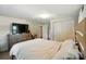 Cozy bedroom features neutral paint, closet, and dresser with TV at 2903 Price Rushing Rd, Monroe, NC 28110