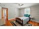 Cozy bedroom with ceiling fan, window, and hardwood flooring at 2903 Price Rushing Rd, Monroe, NC 28110