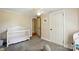 Bright Bedroom with light gray carpet, crib, and window views at 2903 Price Rushing Rd, Monroe, NC 28110