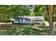 Picturesque home surrounded by lush trees and landscaping offering great curb appeal and a welcoming porch at 2903 Price Rushing Rd, Monroe, NC 28110