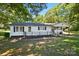 This inviting home boasts a well-manicured lawn, front porch, and neutral paint, offering a welcoming curb appeal at 2903 Price Rushing Rd, Monroe, NC 28110
