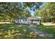 Beautiful home with a welcoming front porch, stone walkway, and lush trees that provide ample shade at 2903 Price Rushing Rd, Monroe, NC 28110
