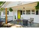 Inviting front porch features a seating area, hanging ferns, and a bright yellow front door for a warm welcome at 2903 Price Rushing Rd, Monroe, NC 28110